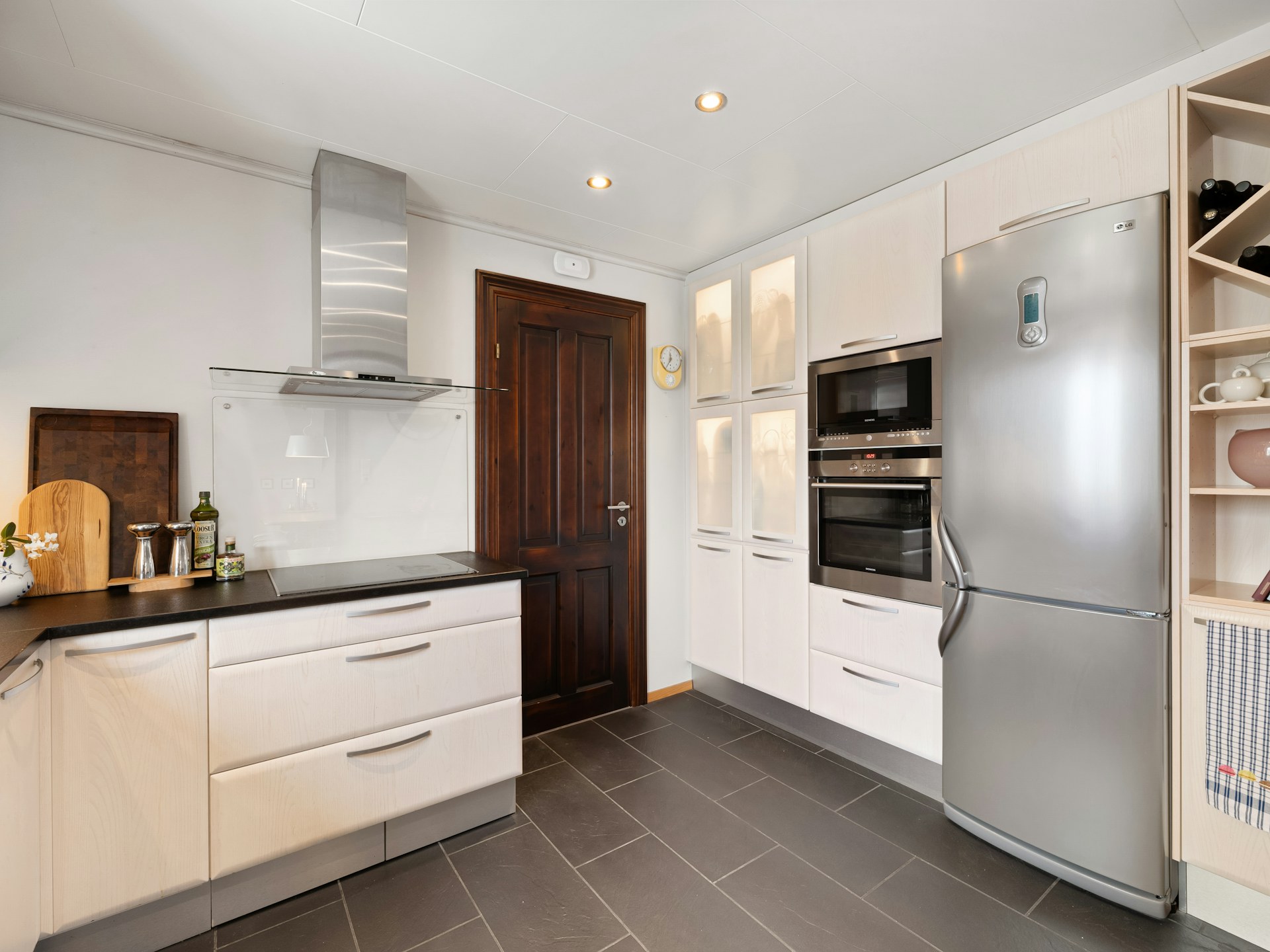 Refrigerator and cooking appliances in a bright home kitchen